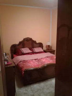 a bedroom with a large bed with pink pillows at Apartman Sutomore in Sutomore