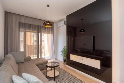 a living room with a couch and a flat screen tv at Soho City A403 in Bar