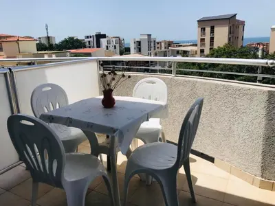 a white table and chairs on a balcony at Apartments ND in Bar