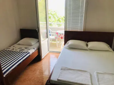 a bedroom with two beds and a balcony at Apartments ND in Bar