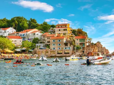 a group of people in boats on a body of water at Blue Horizon Lux Apartment with Pool in Sveti Stefan