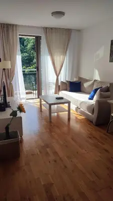 a living room with a couch and a table at Blue Horizon Lux Apartment with Pool in Sveti Stefan