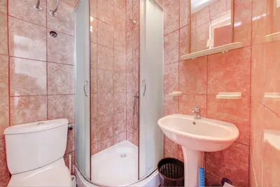 a bathroom with a toilet and a sink and a shower at Pristan Apartments in Dodoši