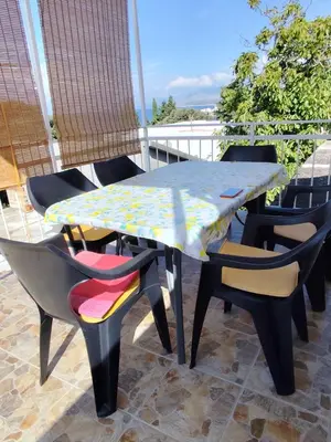 a table and chairs sitting on a patio at Apartman Kosta in Utjeha