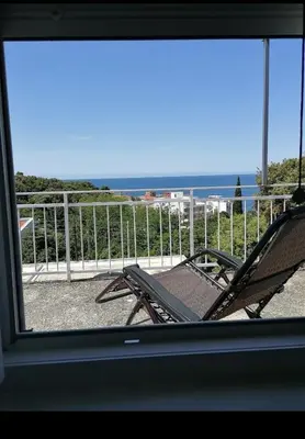 a view of the ocean from a window at Apartman Kosta in Utjeha
