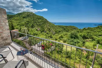 a balcony with a view of the ocean at Vila Stari Mlin in Ivanovići