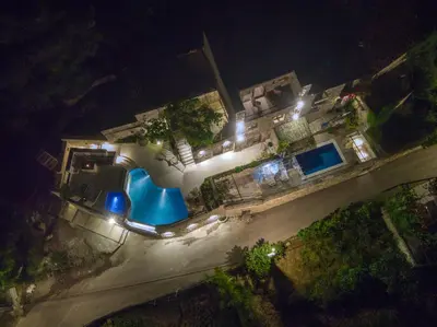 an overhead view of a swimming pool at night at Vila Stari Mlin in Ivanovići