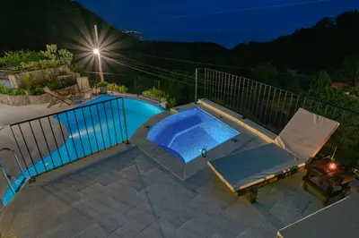 a swimming pool in a backyard at night at Vila Stari Mlin in Ivanovići