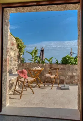 a view of a patio with a table and chairs at Vila Stari Mlin in Ivanovići