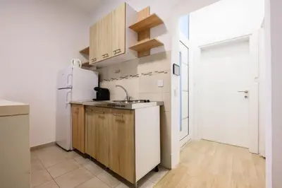 a kitchen with a sink and a refrigerator at Apartmani Vukčević in Bar