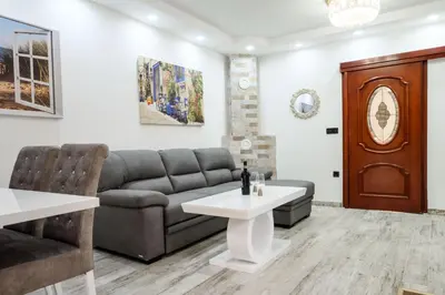 a living room with a couch and a table at Apartmani Vukčević in Bar