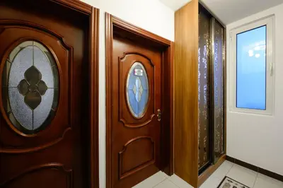 a wooden door in a room with a window at Apartmani Vukčević in Bar