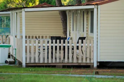 a porch of a house with a fence at HILLS RESORT Beach, Bungalows and Bar - Velika Plaza Ulcinj in Ulcinj