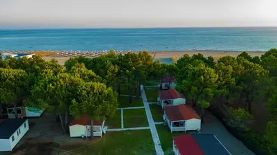 an aerial view of a beach with houses and trees at HILLS RESORT Beach, Bungalows and Bar - Velika Plaza Ulcinj in Ulcinj