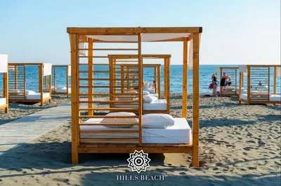 a group of beds on the beach at HILLS RESORT Beach, Bungalows and Bar - Velika Plaza Ulcinj in Ulcinj