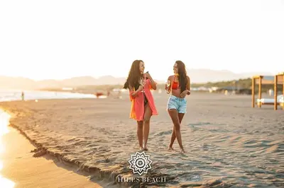 two young women walking on the beach at HILLS RESORT Beach, Bungalows and Bar - Velika Plaza Ulcinj in Ulcinj