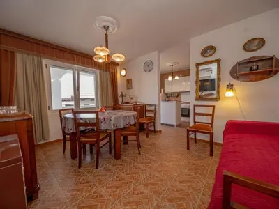 a kitchen and dining room with a table and chairs at Villa Yovan Seaview in Dobra Voda