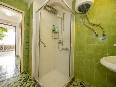 a bathroom with a shower and a sink at Seaview Bosco Apartment in Dobra Voda