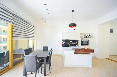 a kitchen and dining room with a table and chairs at Orange Lux Apartments in Budva