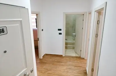 a hallway with a door and a bathroom with a shower at Orange Lux Apartments in Budva