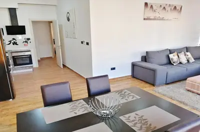 a living room with a table and a couch at Orange Lux Apartments in Budva