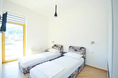 two beds in a room with a window at Orange Lux Apartments in Budva