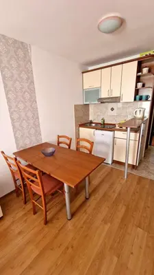 a kitchen and dining room with a wooden table and chairs at Vila Lena in Petrovac na Moru