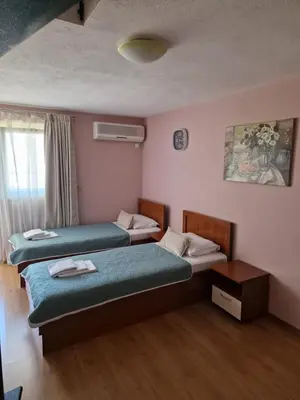 a hotel room with two beds and a window at Vila Lena in Petrovac na Moru