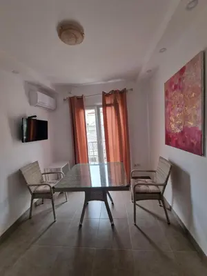 a dining room with a table and two chairs at Vila Lena in Petrovac na Moru