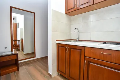 a kitchen with a sink and a mirror at Vila IDILA in Budva