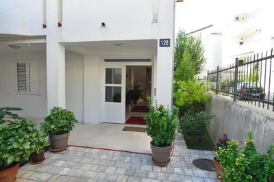 a front door of a house with potted plants at Vila IDILA in Budva