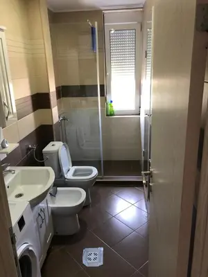 a bathroom with a toilet and a sink and a shower at Square apartment Podgorica in Podgorica