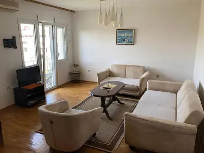 a living room with a couch and chairs and a table at Square apartment Podgorica in Podgorica