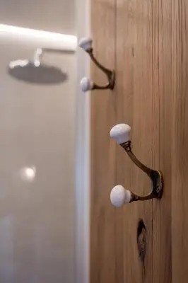 a door with two knobs on a wooden wall at Apartments Hun in Kotor