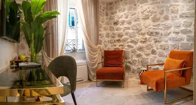 a room with two chairs and a table and a window at Apartments Hun in Kotor