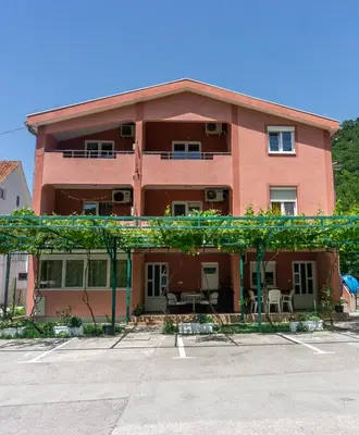a large red building with a lot of windows at Perfect Location close to Jaz beach - Apartments Rora Knezevic in Budva