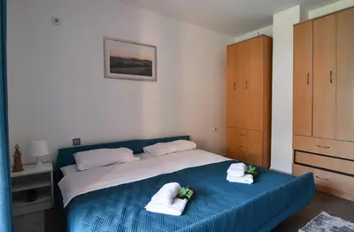 a bedroom with a blue bed with towels on it at Perfect Location close to Jaz beach - Apartments Rora Knezevic in Budva