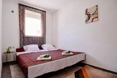 a bedroom with a bed with two towels on it at Perfect Location close to Jaz beach - Apartments Rora Knezevic in Budva
