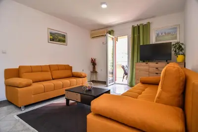 a living room with two couches and a flat screen tv at Perfect Location close to Jaz beach - Apartments Rora Knezevic in Budva