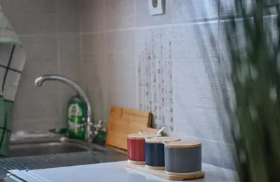 a kitchen with a sink and a counter top withools at Perfect Location close to Jaz beach - Apartments Rora Knezevic in Budva
