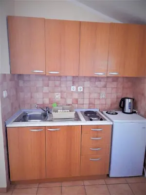 a kitchen with a sink and a stove and a refrigerator at Vila Teodora in Sveti Stefan