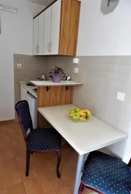 a kitchen with a table with bananas on it at Vila Teodora in Sveti Stefan