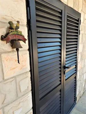 a black door with awell come sign on a wall at Vila Teodora in Sveti Stefan