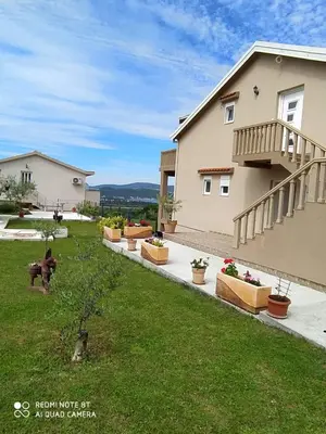 a backyard of a house with potted plants at Apartmani Popović V&A in Tivat