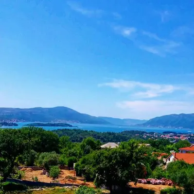 a view of a body of water from a hill at Apartmani Popović V&A in Tivat