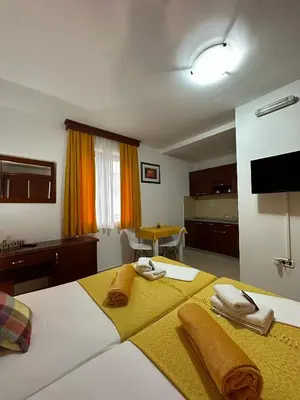 a bedroom with a bed with towels on it at Apartments Krapina Lux in Budva