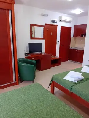 a room with two beds and a desk and a computer at Apartments Krapina Lux in Budva