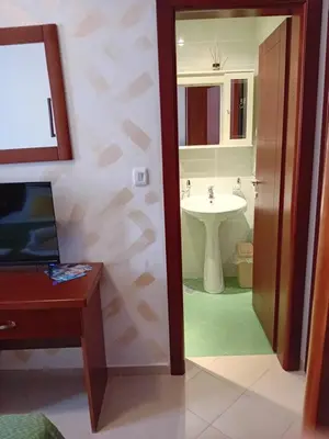 a bathroom with a sink and a toilet and a mirror at Apartments Krapina Lux in Budva