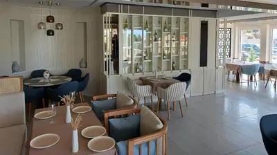 a restaurant with tables and chairs and a dining room at Comfort studio with sea view and swimming pool in Becici