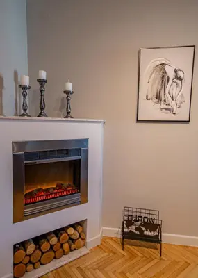a living room with a fireplace and a picture on the wall at City center de Lux apartment in Bar